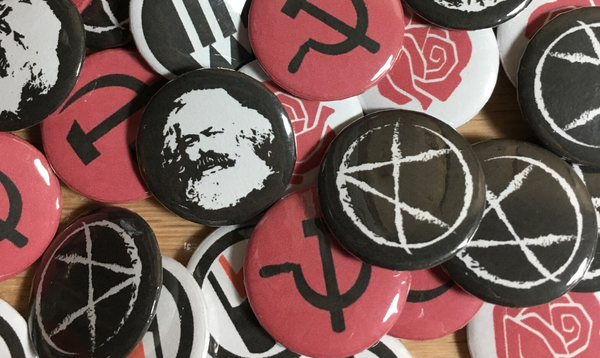Pile of leftist pins: antifa 3 arrows, antifa flags, karl marx's face, circle a, hammer and sickle, and socialist rose.